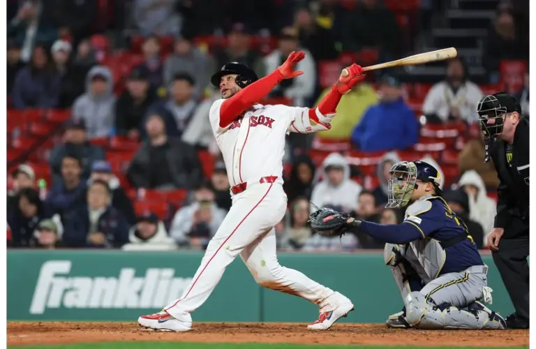 Willson Contreras swinging at a pitch during a game against the Brewers