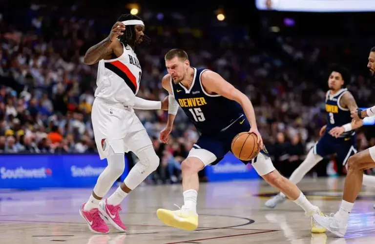 Denver Nuggets center Nikola Jokic (15) controls the ball as Portland Trail Blazers center Robert Williams III (35) guards in the second quarter.