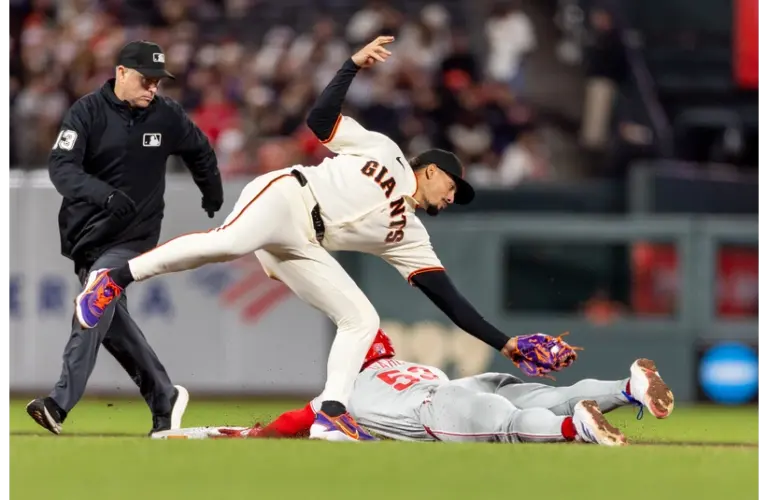 Giants infielder Willy Adames tries to tag a player out