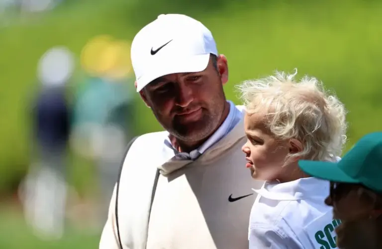 Scottie Scheffler and his son Bennett on the eighth green during the Par 3 Contest.