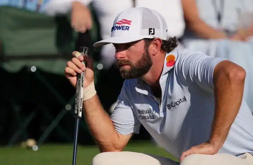 Cameron Young lines up a putt on the 18th green.