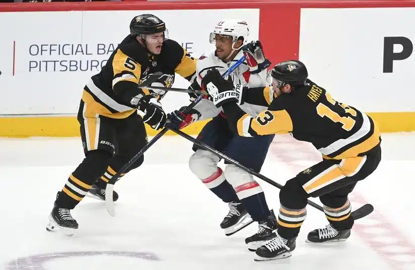 Washington Capitals center Justin Sourdif (34) skates between Pittsburgh Penguins defenseman Ryan Shea (5) and right wing Kevin Hayes (13).