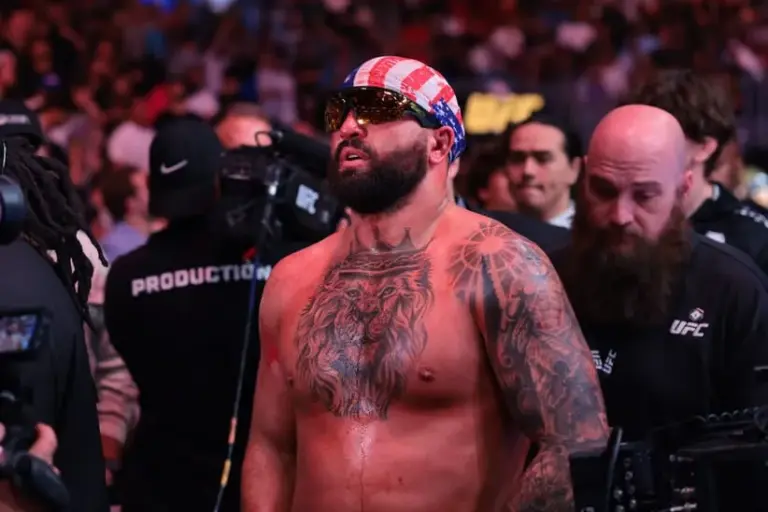 Apr 11, 2026; Miami, Florida, UNITED STATES; Josh Hokit (blue gloves) reacts after the fight against Curtis Blaydes (red gloves) during UFC 327 at Kaseya Center.