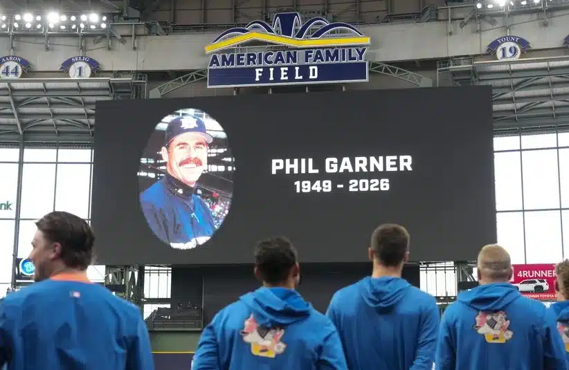 Milwaukee Brewers players observe a moment of silence in honor of former manager Phil Garner.