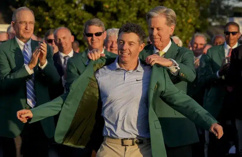 Augusta National Golf Club chairman Fred Ridley places the green jacket on Rory McIlroy during the green jacket ceremony after the final round of the Masters Tournament.