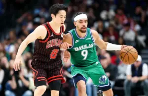 Dallas Mavericks guard Ryan Nembhard (9) dribbles.