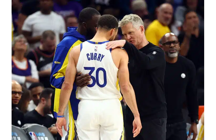 Steph Curry talking to Coach Kerr courtside