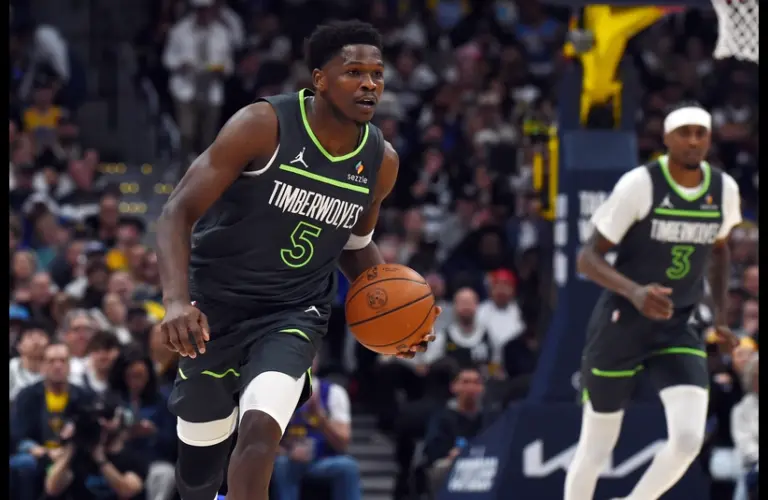 Minnesota Timberwolves guard Anthony Edwards (5) dribbles the ball up the court during the first half against the Denver Nuggets in game one of the first round of the 2026 NBA Playoffs at Ball Arena.