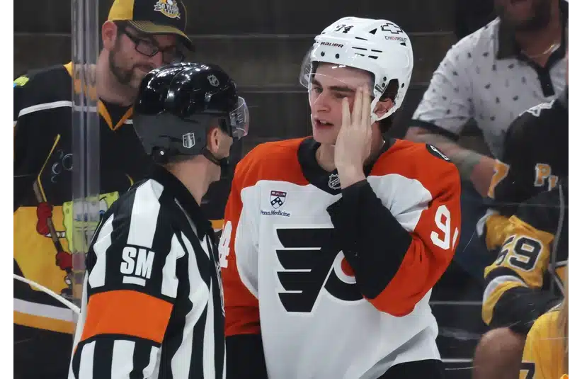 Apr 18, 2026; Pittsburgh, Pennsylvania, USA; Referee Chris Rooney (5) checks Philadelphia Flyers right wing Porter Martone (94) after Martone was high-sticked by the Pittsburgh Penguins during the third period against in game one of the first round of the 2026 Stanley Cup Playoffs at PPG Paints Arena. Mandatory Credit: Charles LeClaire-Imagn Images