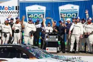 Apr 19, 2026; Kansas City, Kansas, USA; NASCAR Cup Series driver Tyler Reddick (45) holds up the winner’s trophy after winning the AdventHealth 400 at Kansas Speedway.