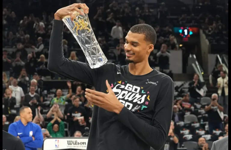San Antonio Spurs forward Victor Wembanyama (1) holds up his Defensive Player of the Year award before game two of the first round of the 2026 NBA Playoffs against the Portland Trail Blazers at Frost Bank Center.