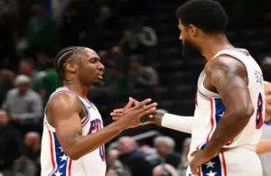 Philadelphia 76ers guard Tyrese Maxey (0) high-fives forward Paul George (8) after a game.