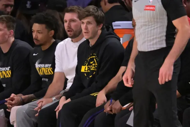Apr 21, 2026; Los Angeles, California, USA; Los Angeles Lakers guard Luka Doncic (77) and guard Austin Reaves (15) look on from the bench.