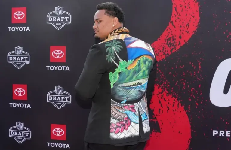 Miami Hurricanes lineman Francis Mauigoa poses on the red carpet.