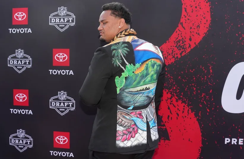 Miami Hurricanes lineman Francis Mauigoa poses on the red carpet.