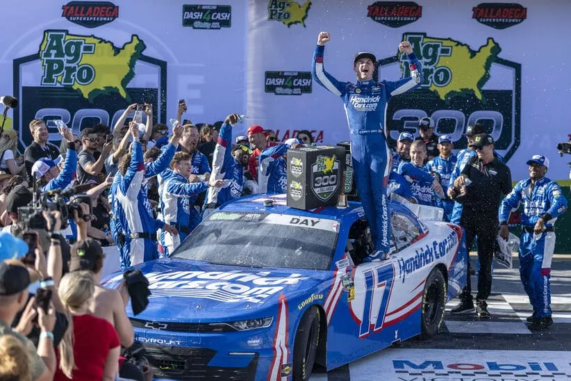 Apr 25, 2026; Talladega, Alabama, USA; O'Reilly Auto Parts Series driver Corey Day (17) celebrates winning the race with his crew after the AG-Pro 300 NASCAR O’Reilly Auto Parts Series race at Talladega Superspeedway.