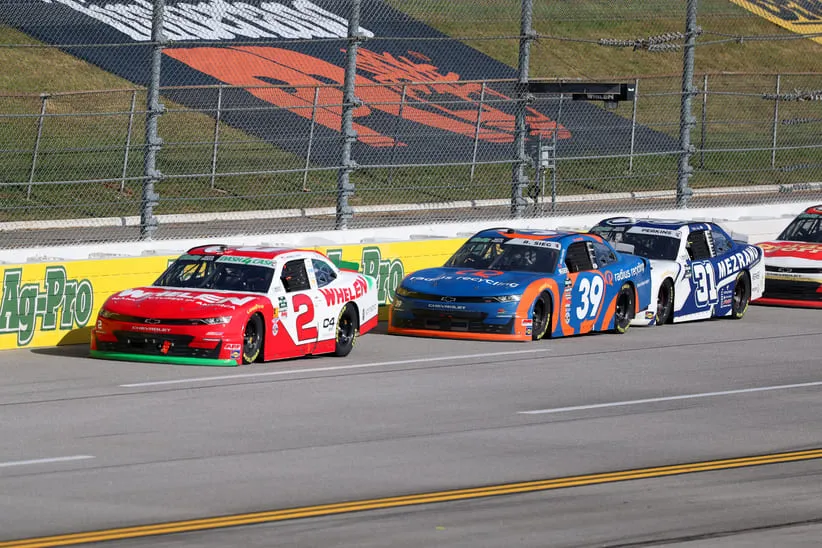 Apr 25, 2026; Talladega, Alabama, USA; O'Reilly Auto Parts Series driver Jesse Love (2) leads against O'Reilly Auto Parts Series driver Ryan Sieg (39) and O'Reilly Auto Parts Series driver Blaine Perkins (31) during the AG-Pro 300 NASCAR O'Reilly Auto Parts Series race at Talladega Superspeedway.