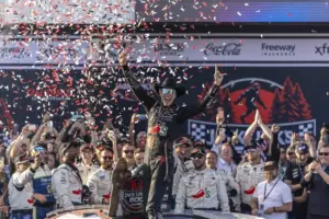 Apr 26, 2026; Talladega, Alabama, USA; NASCAR Cup Series driver Carson Hocevar (77) celebrates winning the Jack Links 500 NASCAR Cup Series race in Victory Lane at Talladega Superspeedway.