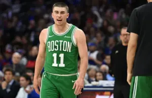Boston Celtics guard Payton Pritchard (11) reacts after making a three point basket.