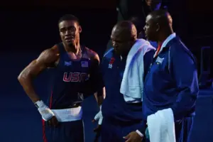 Aug 3, 2012; London, United Kingdom; Errol Spence (USA), blue, and coach Derrick James, center, react after losing to Krishan Vikas (IND), red, in the men's welter (69kg) round of 16 bout 5 of boxing during the London 2012 Olympic Games at ExCeL - South Arena 2.