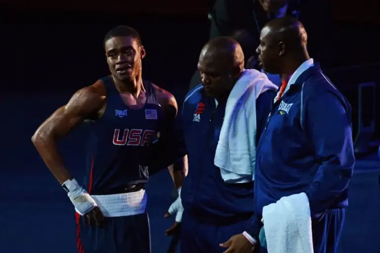 Aug 3, 2012; London, United Kingdom; Errol Spence (USA), blue, and coach Derrick James, center, react after losing to Krishan Vikas (IND), red, in the men's welter (69kg) round of 16 bout 5 of boxing during the London 2012 Olympic Games at ExCeL - South Arena 2.