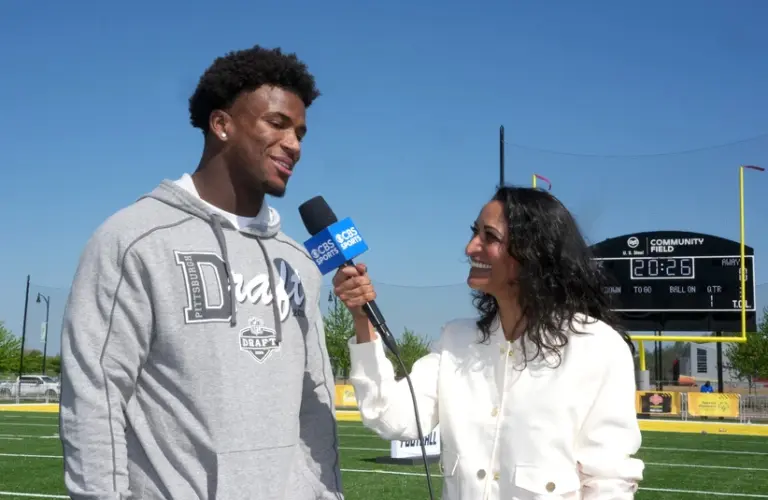 Apr 22, 2026; Pittsburgh, PA, USA; Ohio State Buckeyes defensive back Caleb Downs (left) is interviewed by CBS Sports female reporter Aditi Kinkhabwala during the NFL Draft prospects clinic at Hazelwood Green Park.