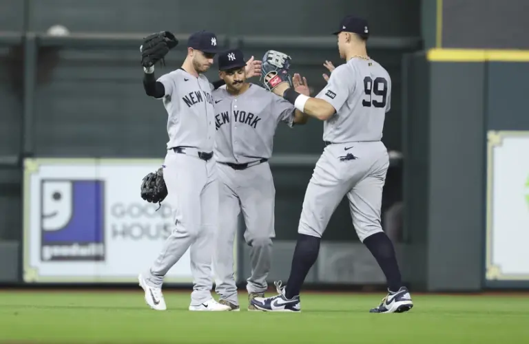 Apr 25, 2026; Houston, Texas, USA; New York Yankees left fielder Cody Bellinger (35) and center fielder Trent Grisham (12) and right fielder Aaron Judge (99) celebrate after the game against the Houston Astros at Daikin Park.