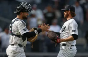 May 2, 2026; Bronx, New York, USA; New York Yankees pitcher Paul Blackburn (58) and catcher J.C. Escarra (25) celebrate after drafting the Baltimore Orioles at Yankee Stadium.