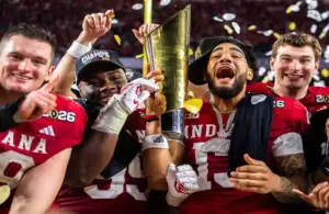 Indiana's Pat Coogan (78), Tyrique Tucker (95), Elijah Sarratt (13) and Fernando Mendoza (15) celebrate with the trophy after the College Football Playoff National Championship college football game at Hard Rock Stadium in Miami Gardens on Monday, Jan. 19, 2026.