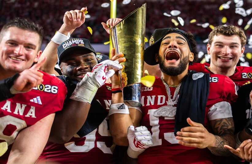 Indiana's Pat Coogan (78), Tyrique Tucker (95), Elijah Sarratt (13) and Fernando Mendoza (15) celebrate with the trophy after the College Football Playoff National Championship college football game at Hard Rock Stadium in Miami Gardens on Monday, Jan. 19, 2026.