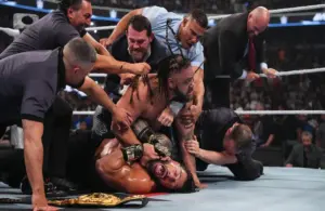 Jacob Fatu applying the Togan Death Grip to Roman Reigns after their match at Backlash Tampa.
