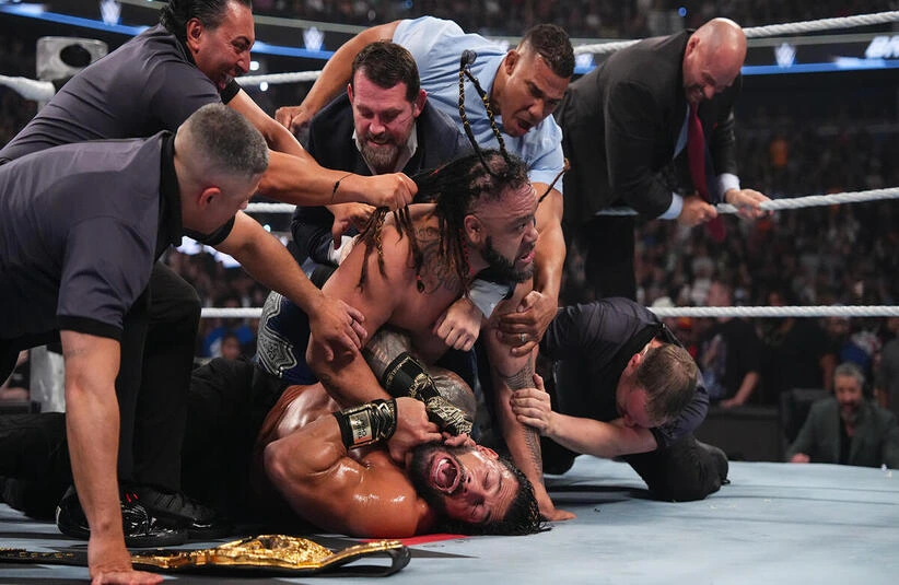 Jacob Fatu applying the Togan Death Grip to Roman Reigns after their match at Backlash Tampa.