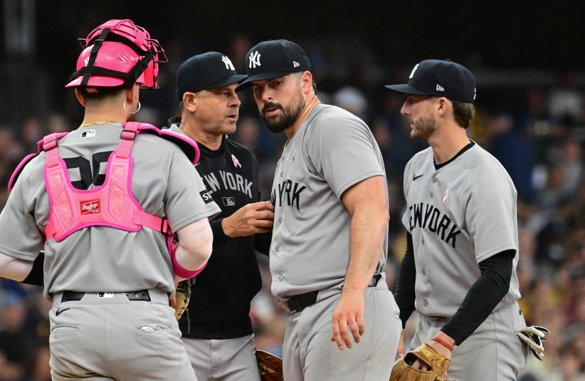May 10, 2026; Milwaukee, Wisconsin, USA; New York Yankees starting pitcher Carlos Rodon (55) hands the ball to manager Aaron Boone during a pitching change in the fifth inning against the Milwaukee Brewers at American Family Field.