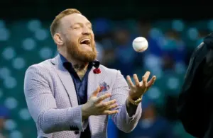 Conor McGregor tosses the ball after throwing out a ceremonial first pitch.