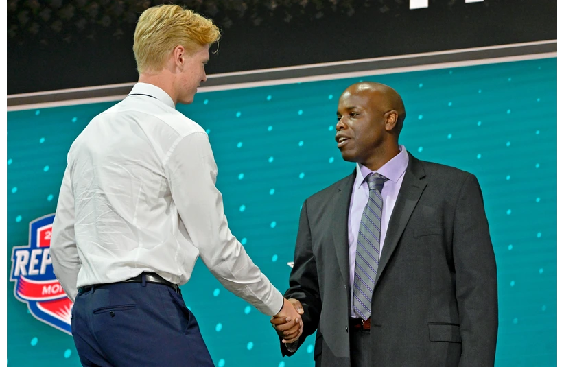 Jul 7, 2022; Montreal, Quebec, CANADA; Filip Bystedt shakes hands with San Jose Sharks general manager Mike Grier after being selected as the number twenty-seven overall pick to the San Jose Sharks in the first round of the 2022 NHL Draft at Bell Centre. Mandatory Credit: Eric Bolte-Imagn Images