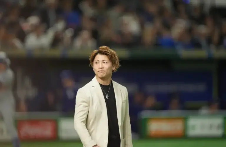 Professional Boxer Naoya Inoue walks onto the mound before throwing a ceremonial first pitch.