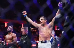 Carlos Prates (blue gloves) reacts after defeating Leon Edwards.