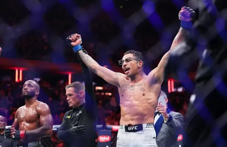 Carlos Prates (blue gloves) reacts after defeating Leon Edwards.