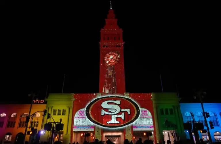The San Francisco 49ers logo is projected on the Ferry Building.