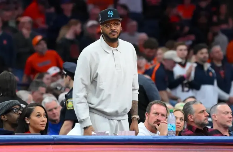 Hall of fame member Carmelo Anthony looks on.