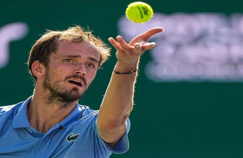 Daniil Medvedev readies a serve to Jannik Sinner.