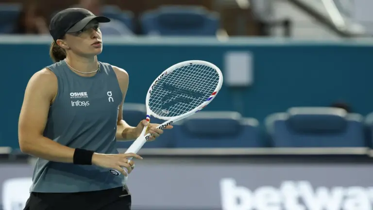 Iga Swiatek (POL) reacts after missing a shot
