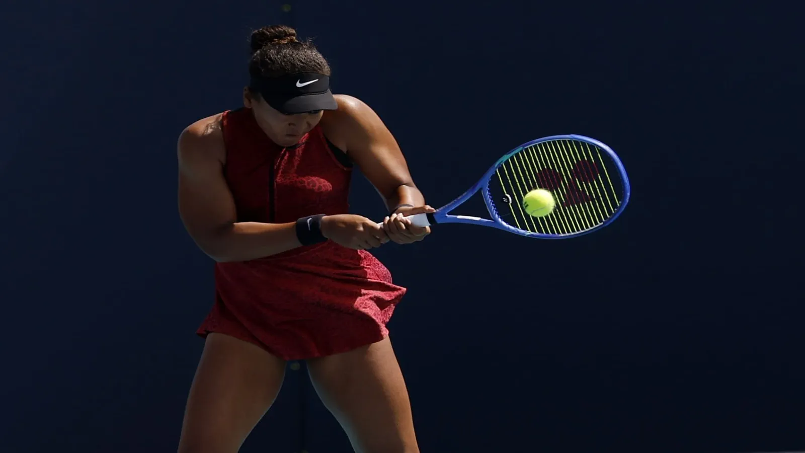 Naomi Osaka (JPN) hits a backhand.