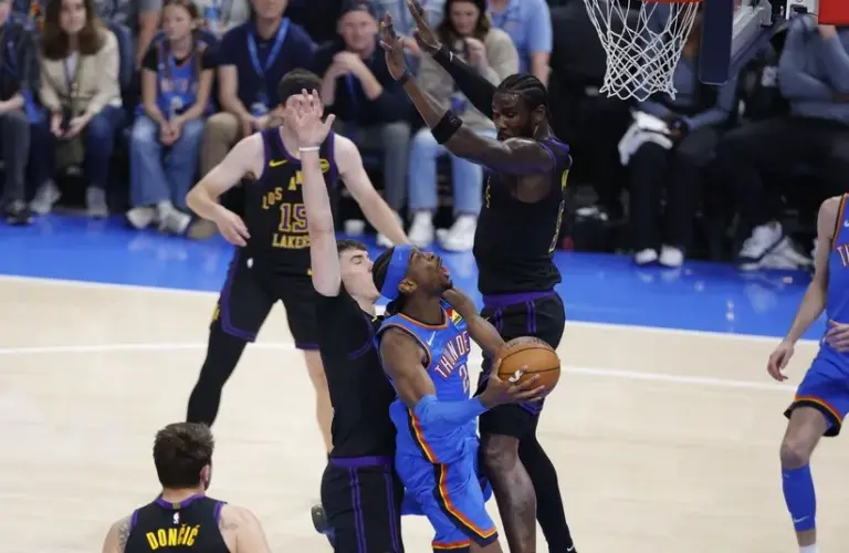 Oklahoma City Thunder guard Shai Gilgeous-Alexander (2) shoots from under the basket against the Los Angeles Lakers.