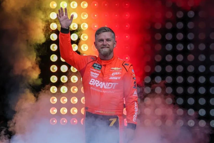 Apr 18, 2026; Kansas City, Kansas, USA; NASCAR O’Reilly Auto Parts Series driver Justin Allgaier (7) waves to the crowd during driver introductions before the Kansas Lottery 300 at Kansas Speedway.