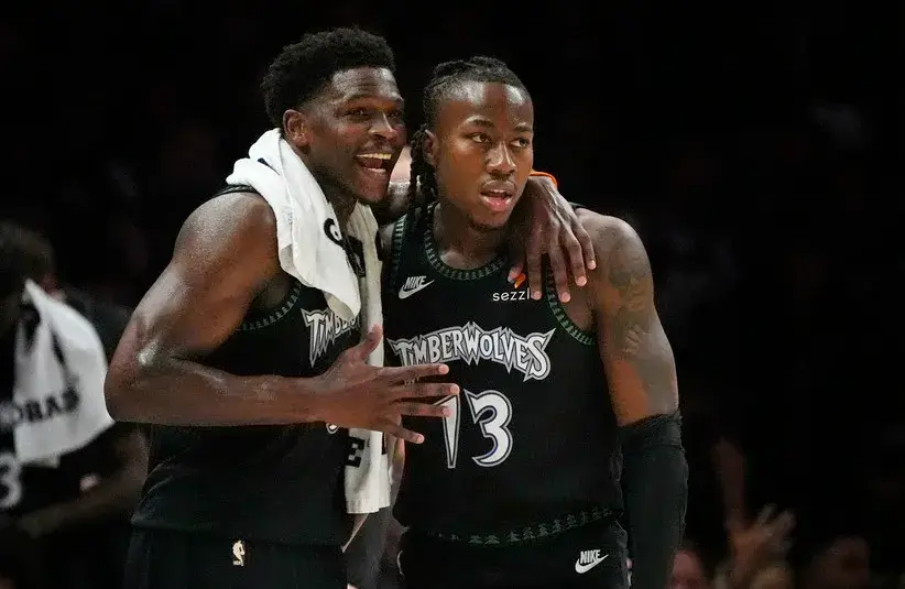 Apr 23, 2026; Minneapolis, Minnesota, USA; Minnesota Timberwolves guard Anthony Edwards (5) talks with guard Ayo Dosunmu (13) during a free throw by the Denver Nuggets in the first quarter at Target Center. Mandatory Credit: Bruce Kluckhohn-Imagn Images