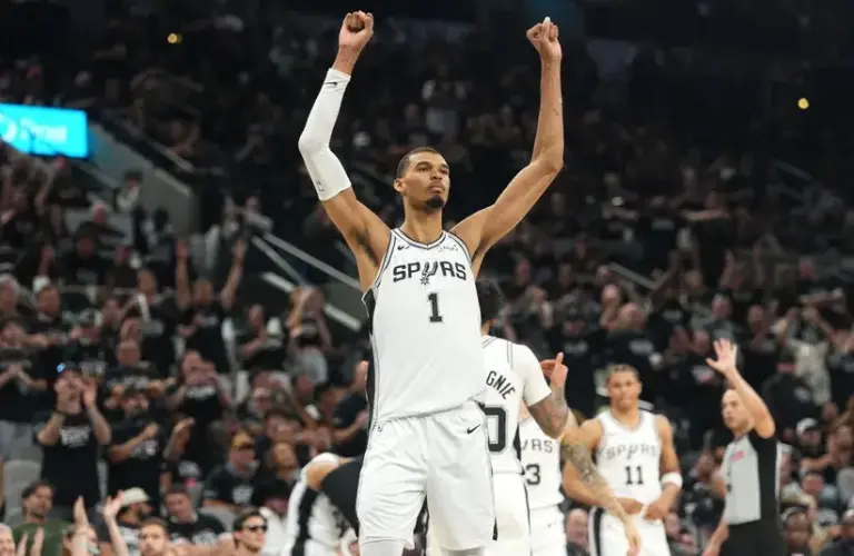San Antonio Spurs forward Victor Wembanyama (1) raises his arms and acknowledges the fans before leaving during the second half of game five of the first round of the 2026 NBA Playoffs against the Portland Trail Blazers.