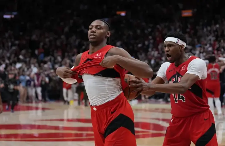 Toronto Raptors forward RJ Barrett (9) celebrates after scoring the winning basket guard Ja'kobe Walter (14) against the Cleveland Cavaliers during the overtime period in game six of the first round of the 2026 NBA Playoffs.