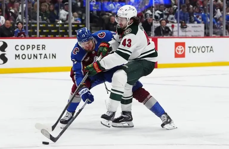 Colorado Avalanche right wing Valeri Nichushkin (13) defends a shot on goal by Minnesota Wild defenseman Quinn Hughes (43).