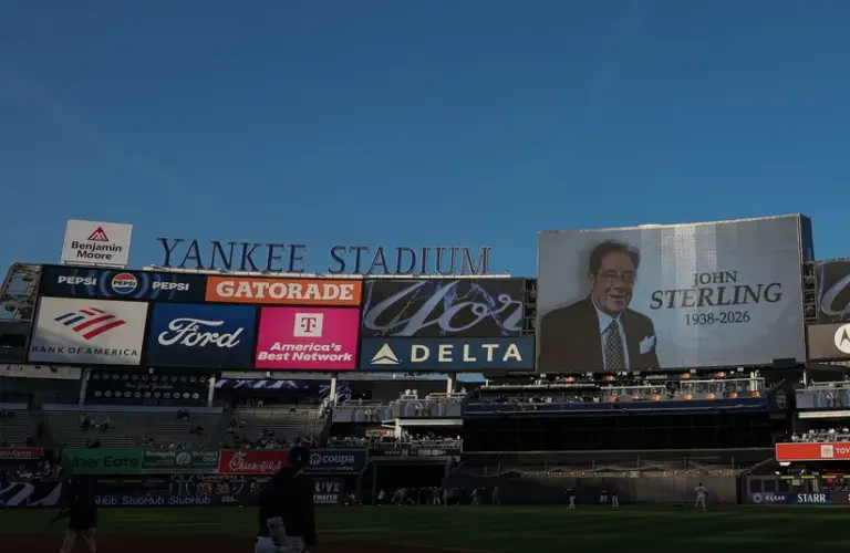 The main scoreboard displays a message honoring John Sterling, the Yankees radio play-by-play announcer.